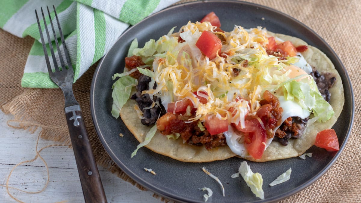 huevos rancheros topped with colorful toppings.