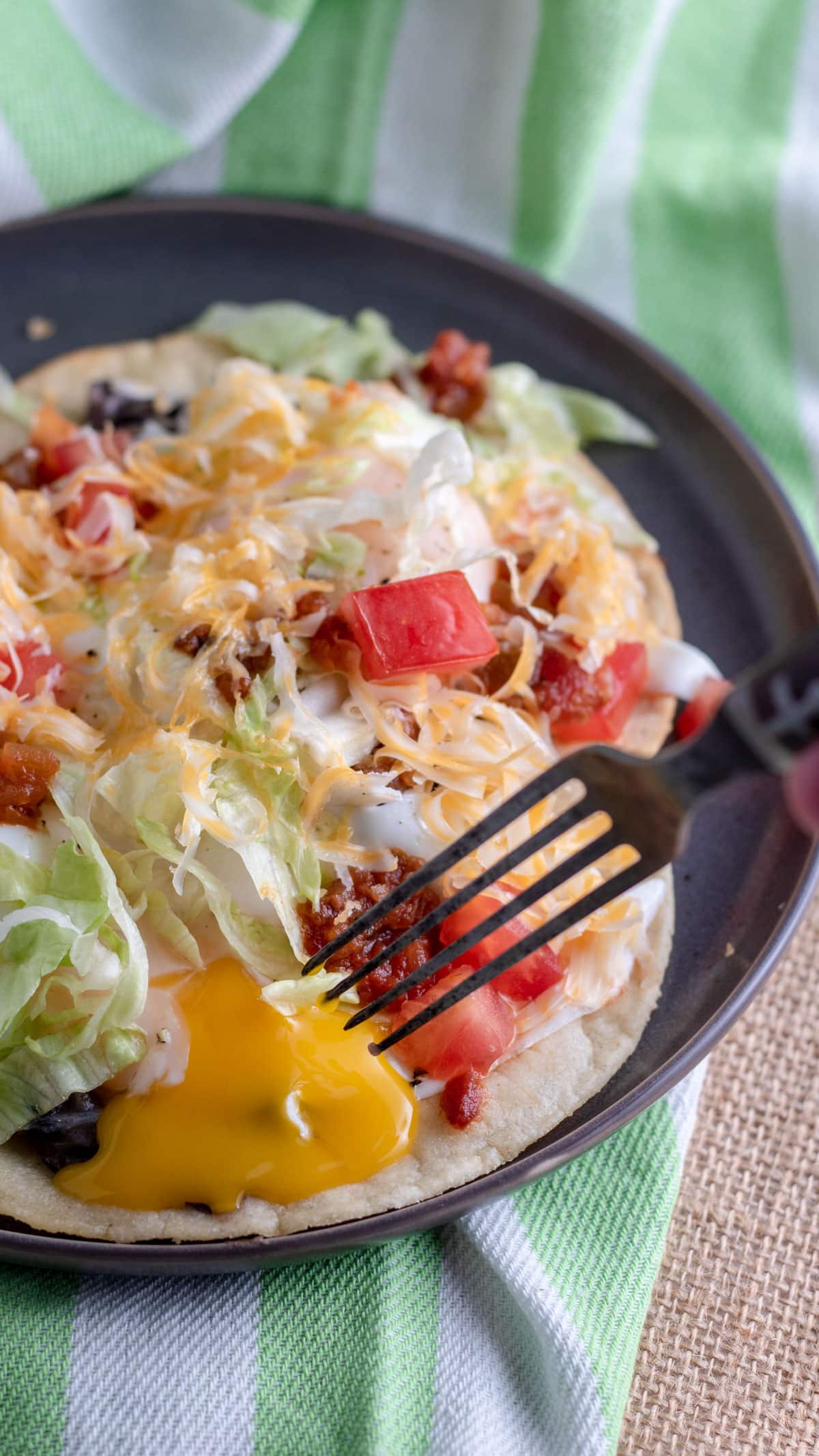 Egg yolk breaking on huevos rancheros.