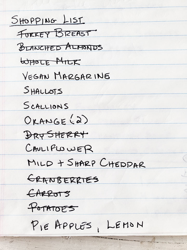 Shopping list with purchased items crossed out.