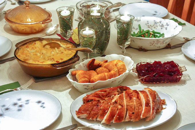Table with holiday meal just before serving.