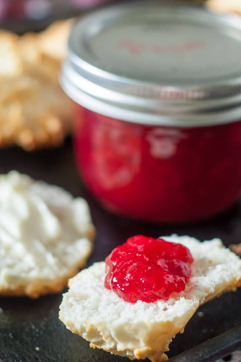 plum jam on metal baking tray with biscuits and jar of jam plum jam on metal baking tray with biscuits and jar of jam