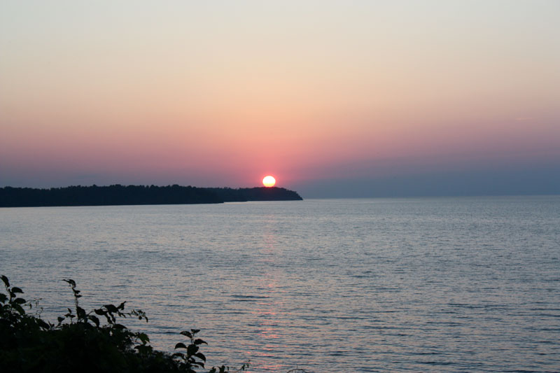 orange sunset with silhouette of sailboat orange sunset with silhouette of sailboat