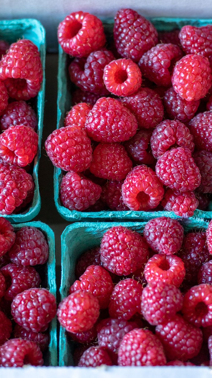 Close up fresh raspberries in baskets.