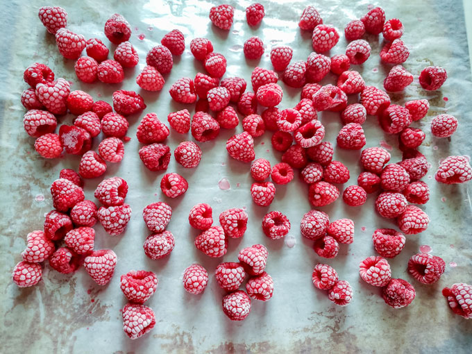 Frozen raspberries on sheet.
