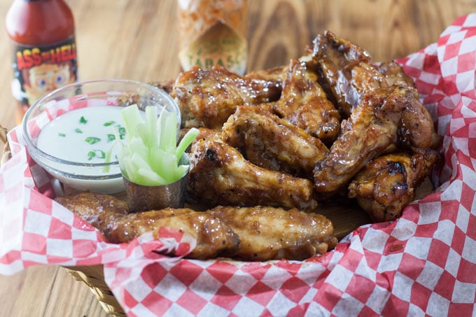 air fryer chicken wings in basket with red and white checked paper