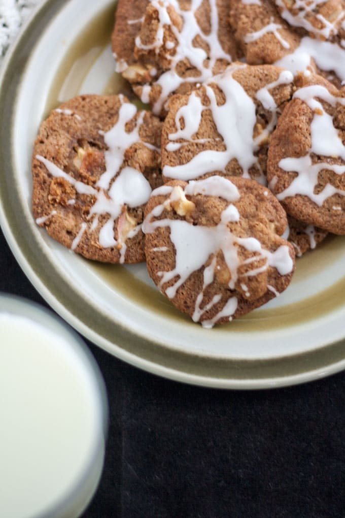 Cookies on plate with glass of milk.