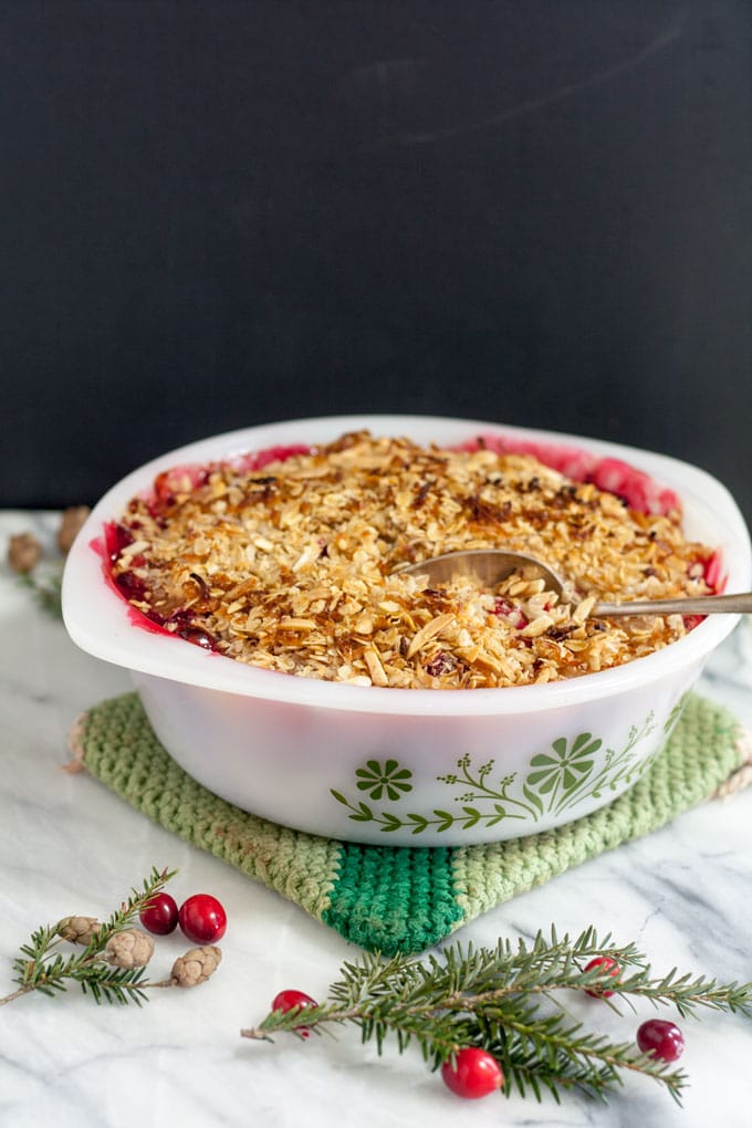 Apple cranberry crisp in white vintage casserole.