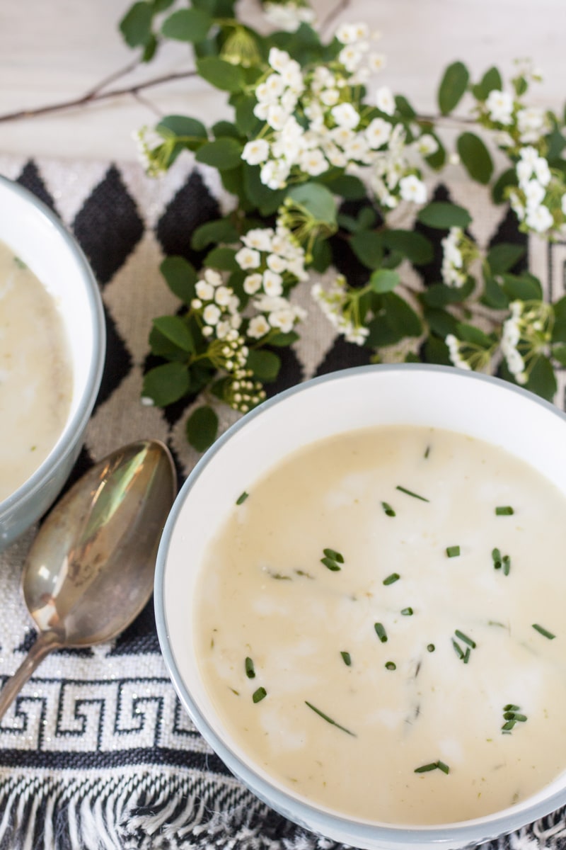 Finished soup in blue bowl with chive garnish