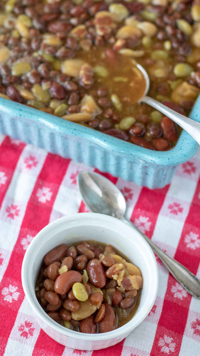 white bowl and blue casserole with baked beans
