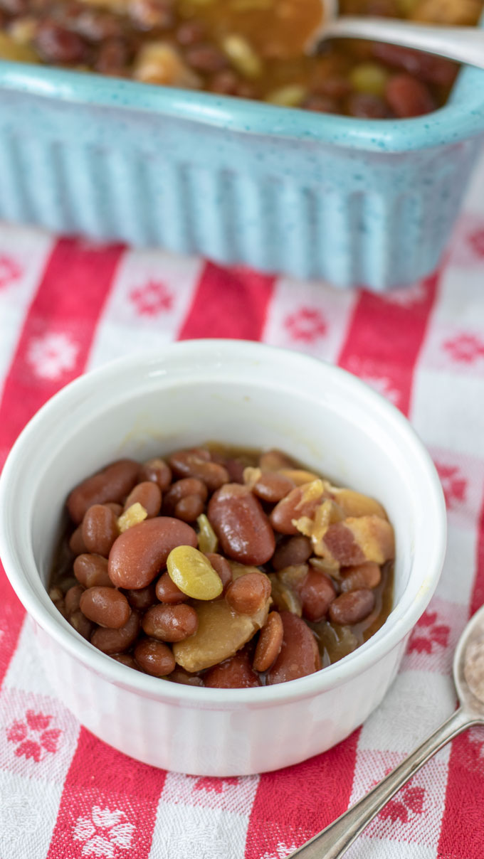 white ramekin with serving of colorful baked beans