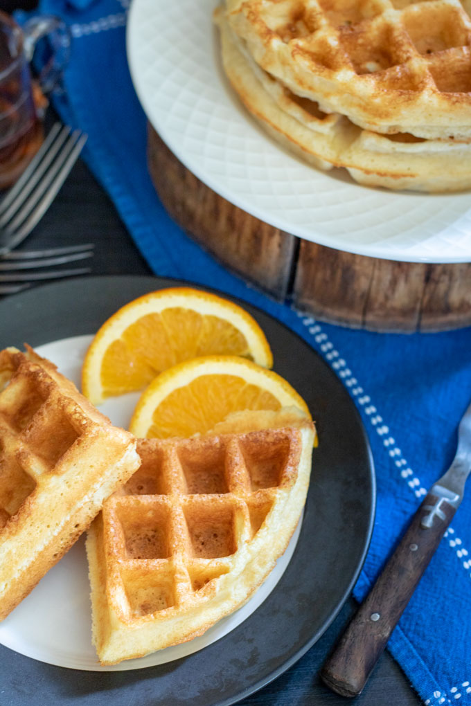 overhead photo Belgian waffles on white and black plate