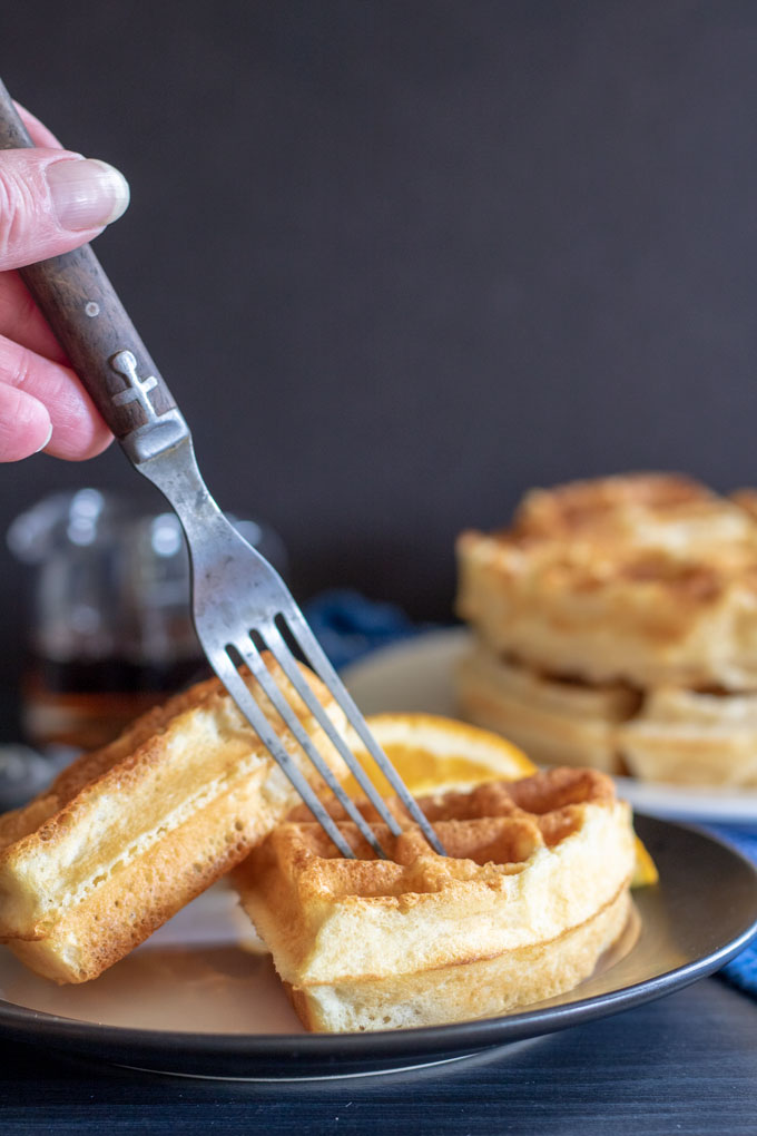 rustic fork cutting into waffle