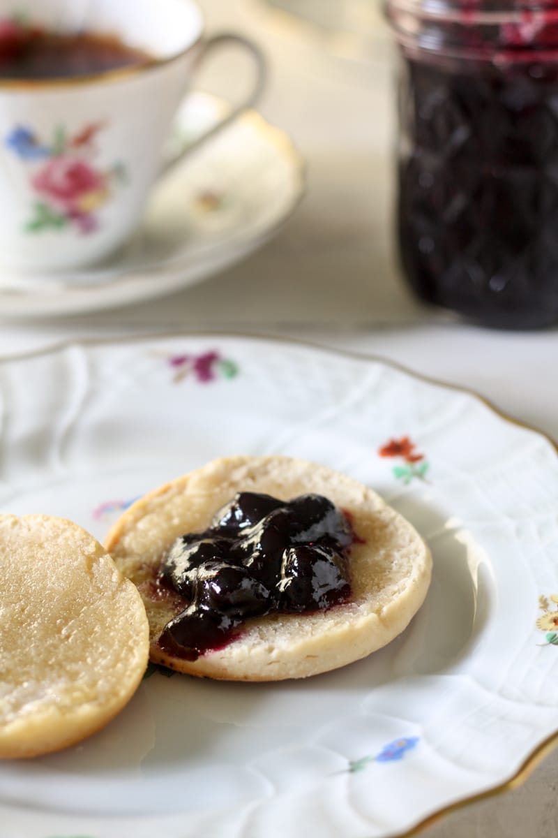 a biscuit with blueberry and tea cup
