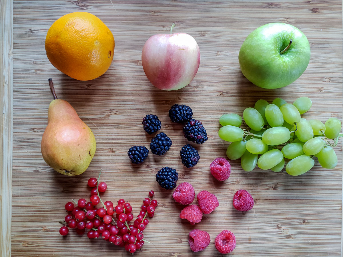 Mixed fruits on wooden board.