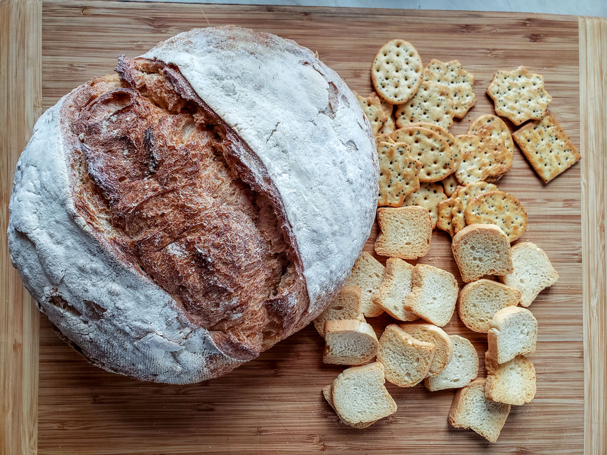 Large loaf of bread, and crackers and toasts.