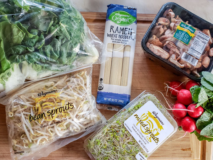 Chicken ramen ingredients on wooden board.