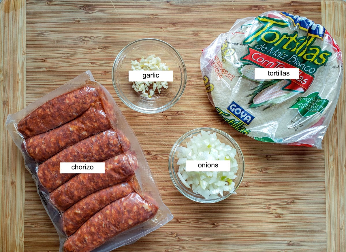 chorizo sausage, garlic, onion and tortillas on board.
