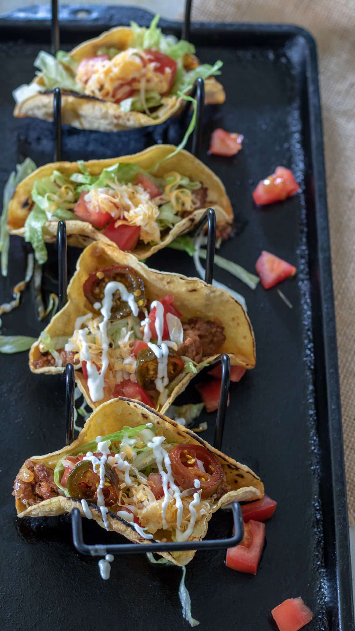 5 tacos lined up in taco holder.