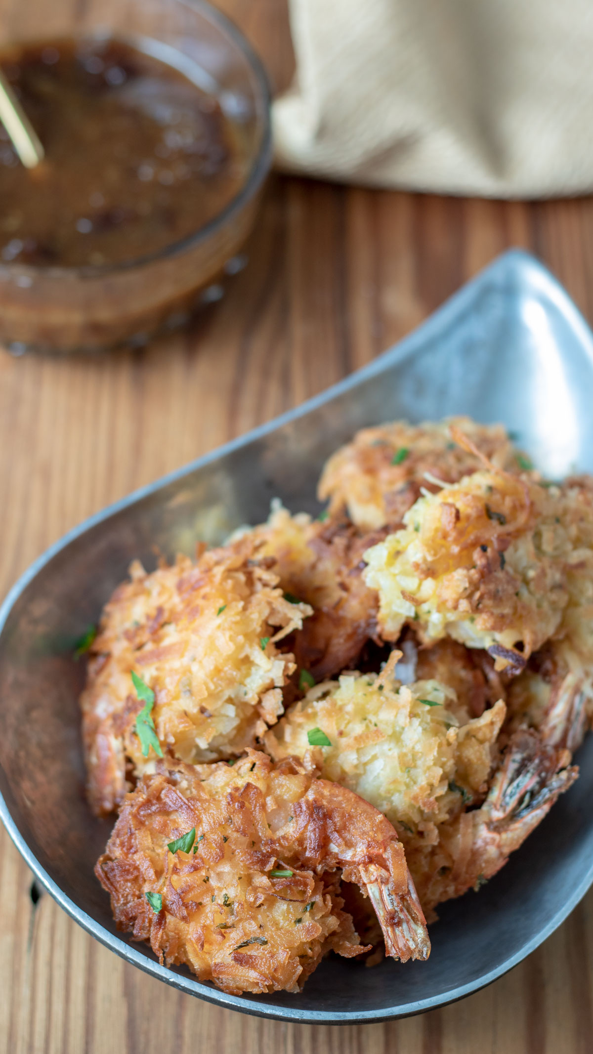 Coconut Shrimp on pewter teardrop shaped bowl.
