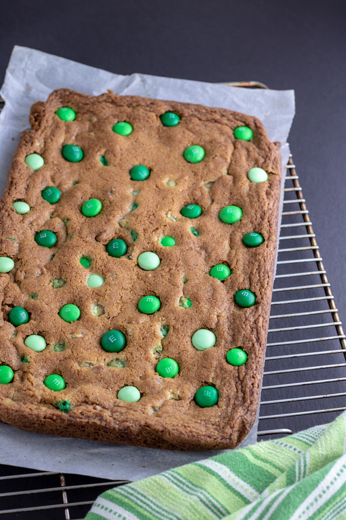 Whole cookie bars, before cutting on parchment paper
