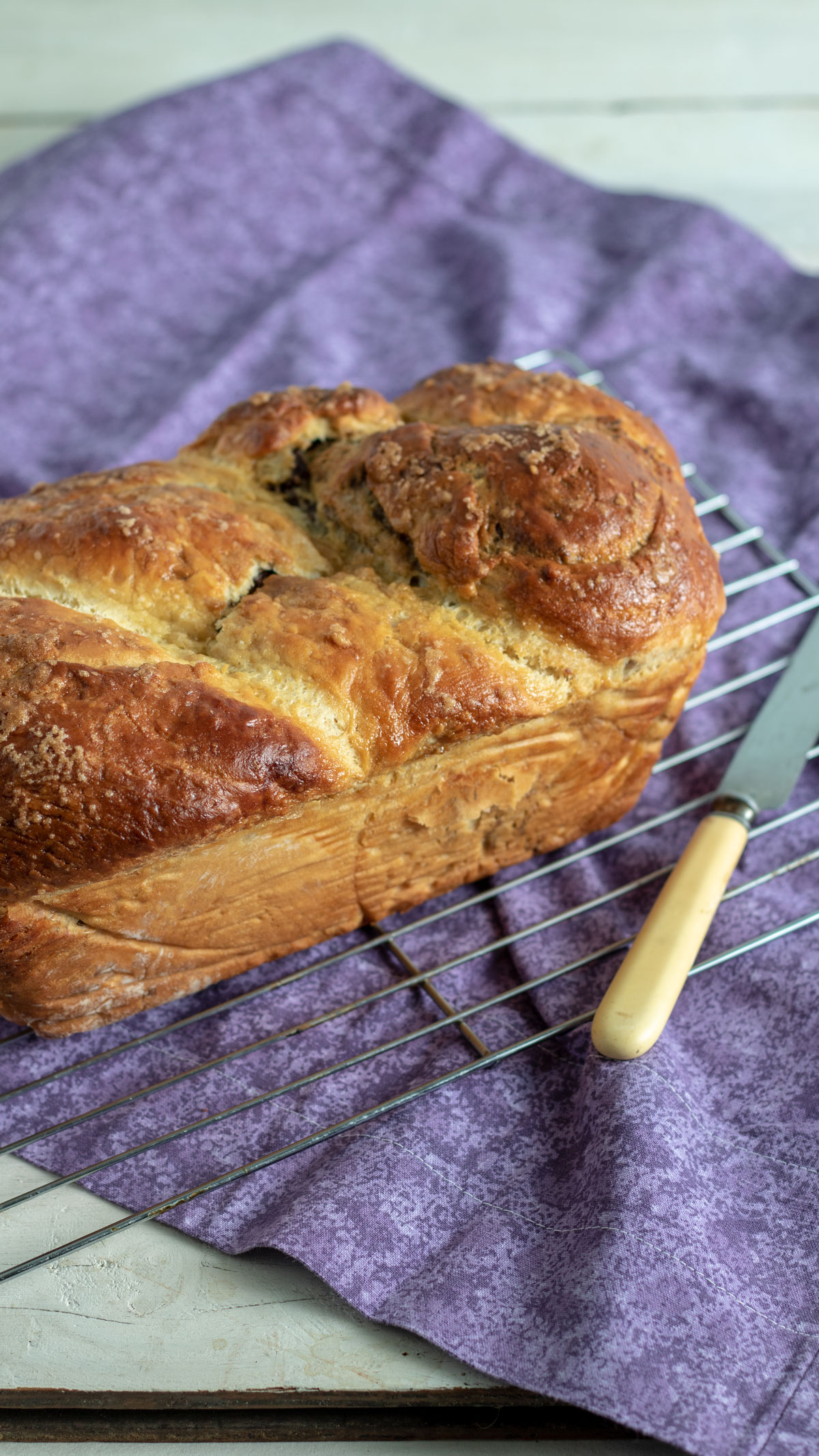 Whole loaf of cozonac on wire rack. 