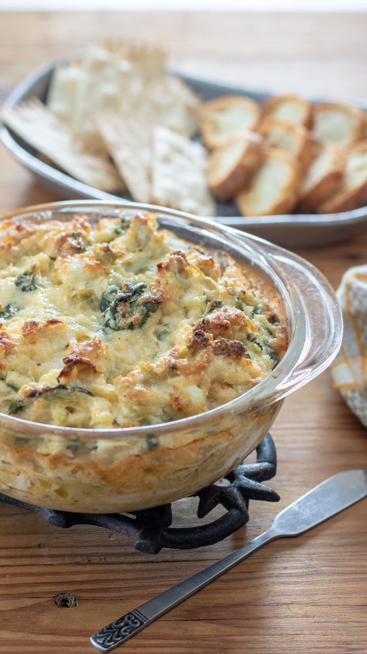 Dip in casserole with tray of crackers of bread.