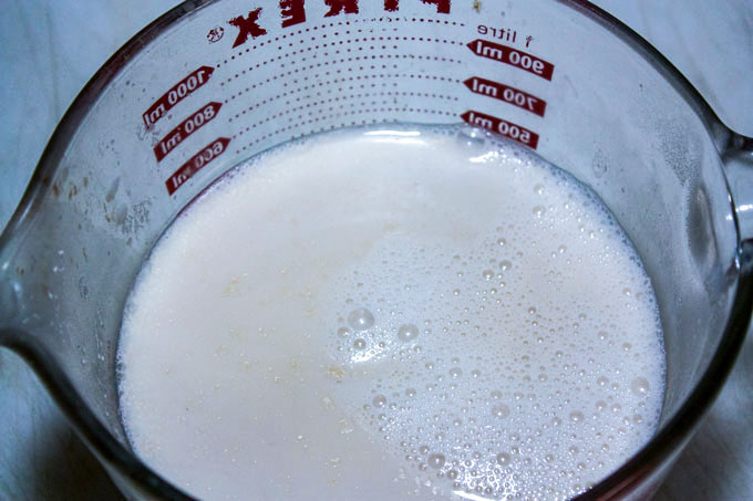 measuring evaporated milk in large measuring cup