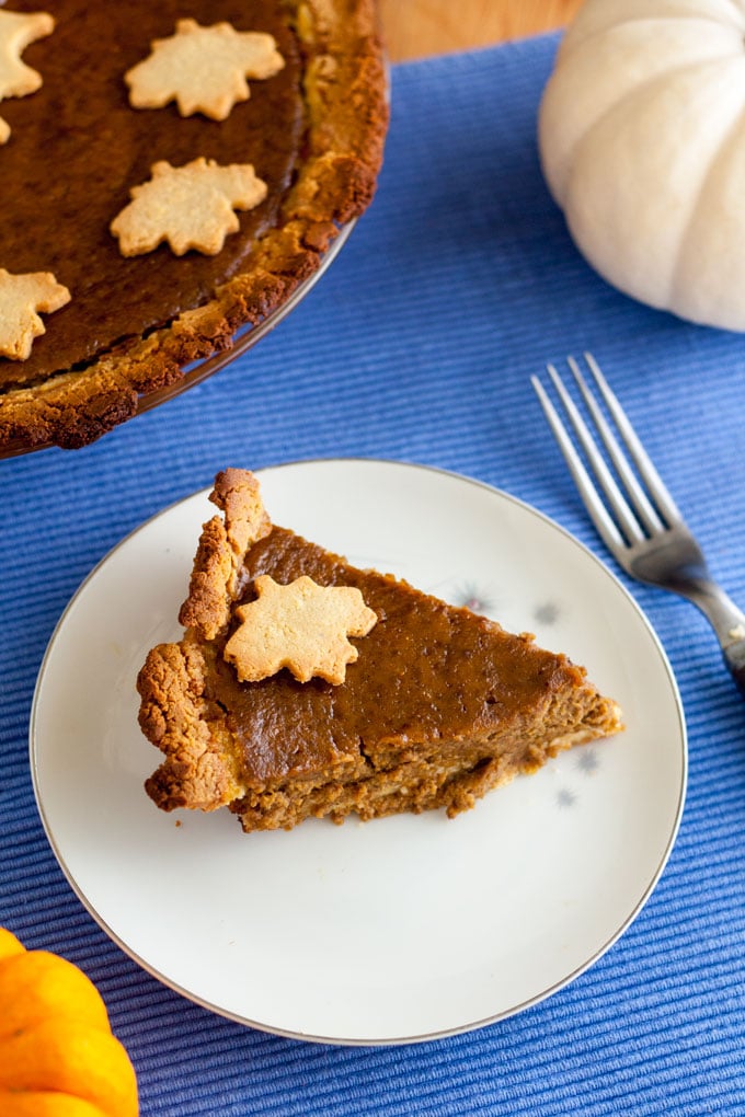 cut slice of dairy free pumpkin pie on white plate