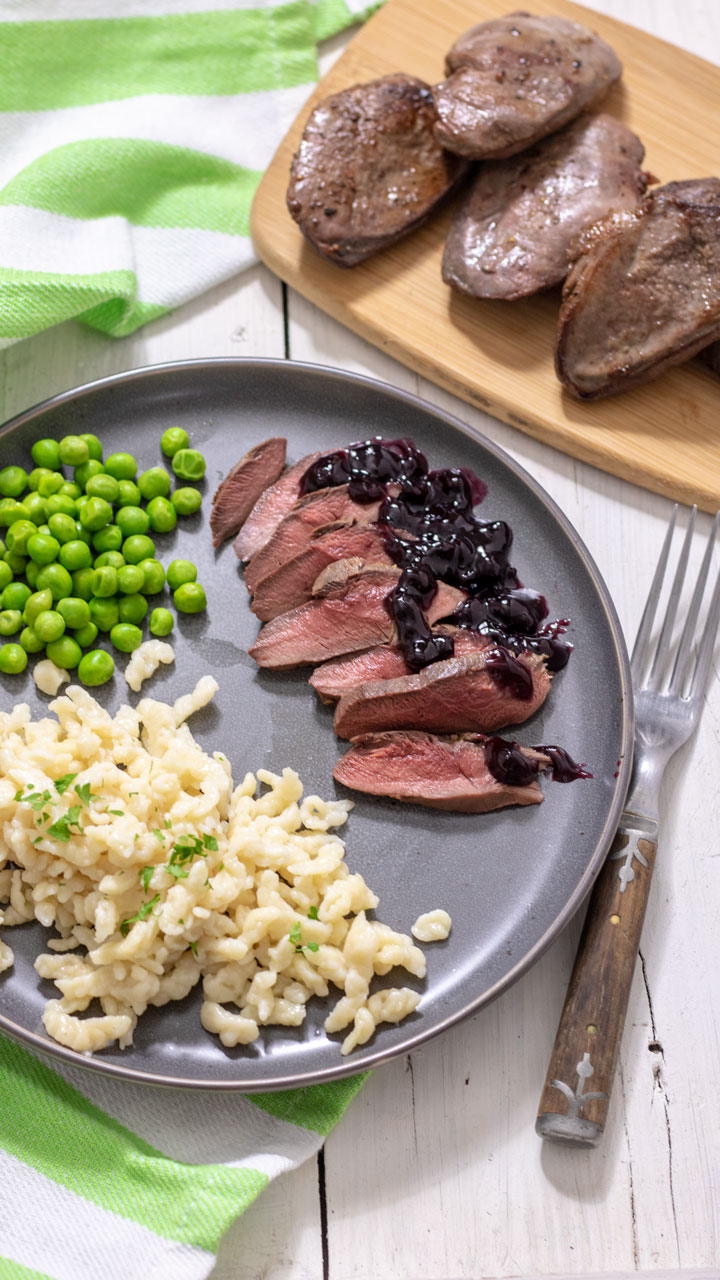 Sliced duck served with sauce and spaetzle.