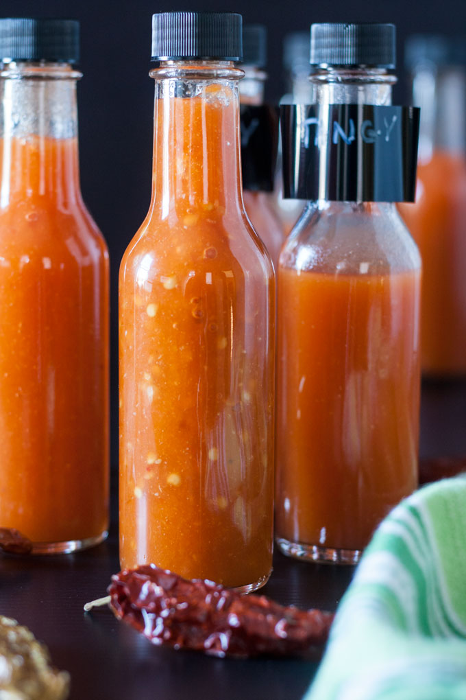 bottles of hot sauce made after planting a vegetable garden