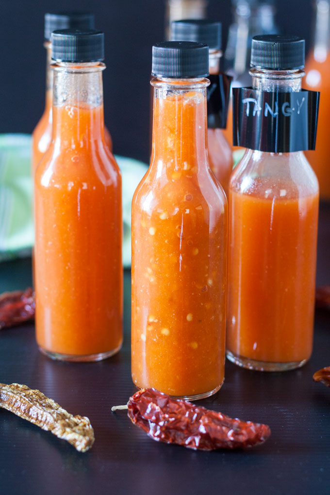 strained fermented hot sauce in glass bottles