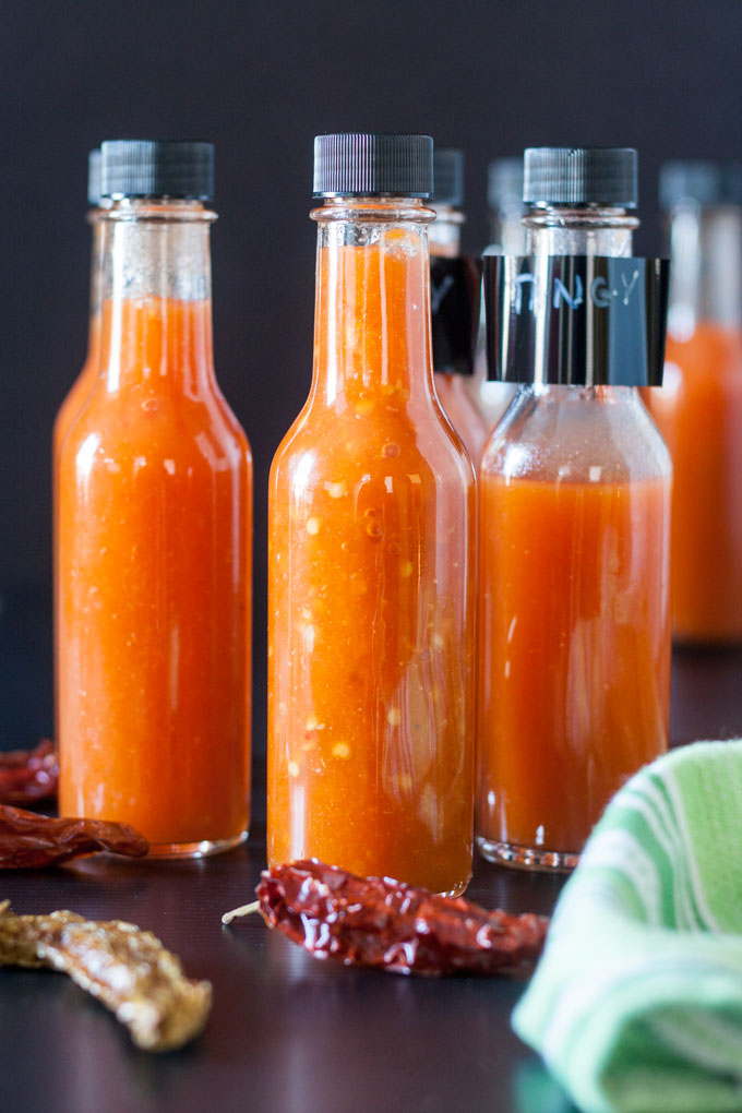 bottle of hot sauce on wooden board