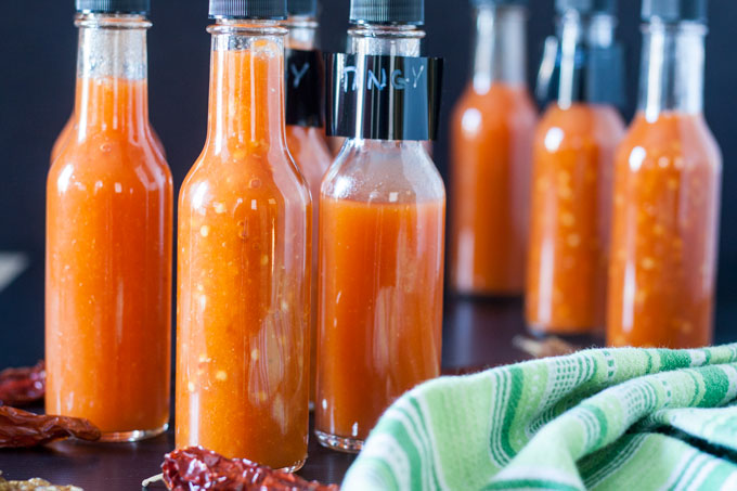 10 bottles filled with hot sauce