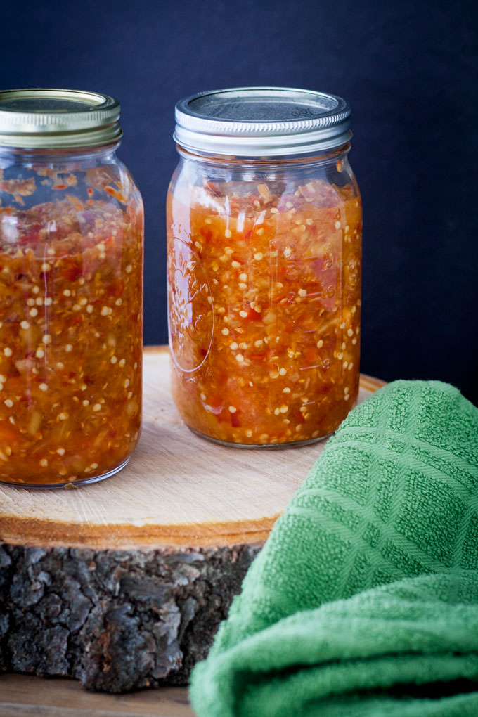 Close up of peppers in jars.