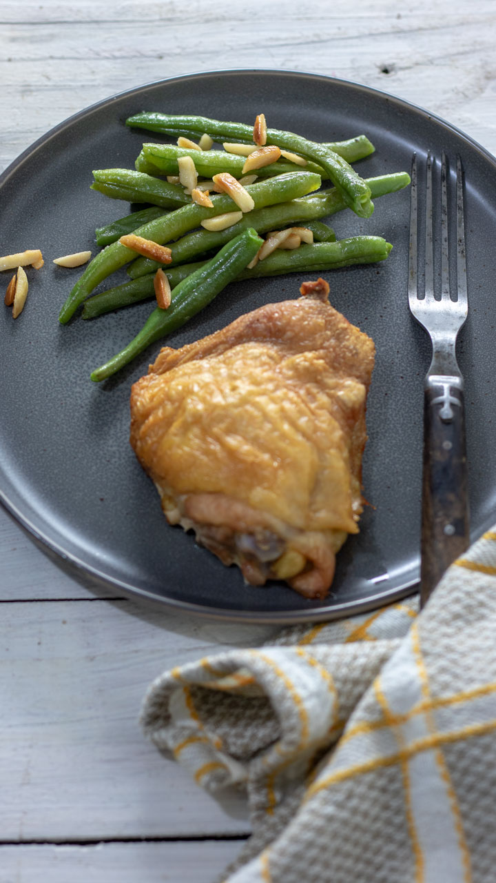 Green beans almondine served with chicken dinner.