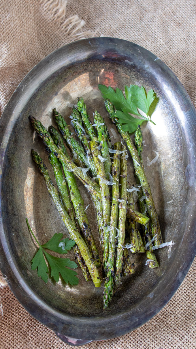 grilled asparagus on silver platter