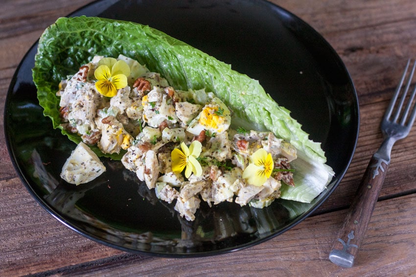 grilled chicken salad on black plate