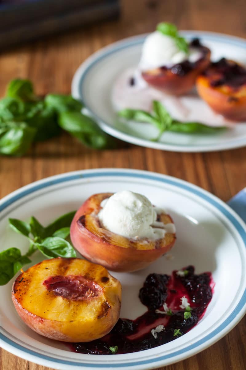 peach halves with grill lines and topped with ice cream