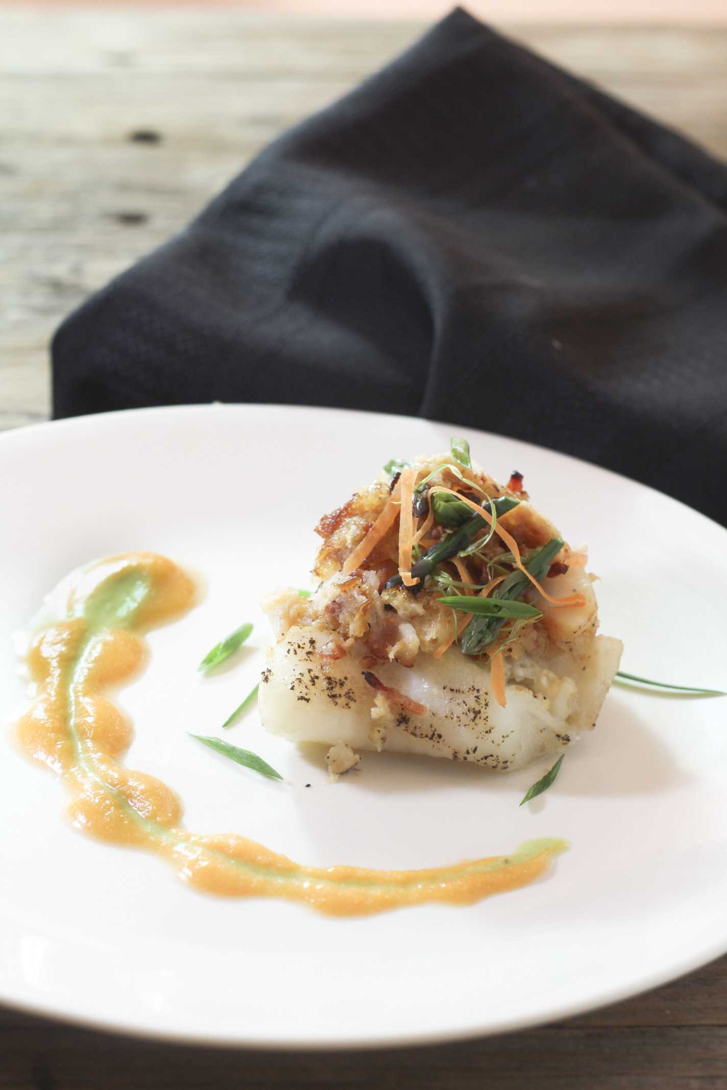 Bacon Horseradish Lobster Stuffed Grouper on white plate with fancy plating