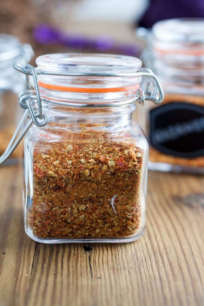 close up of square glass jar with chili powder