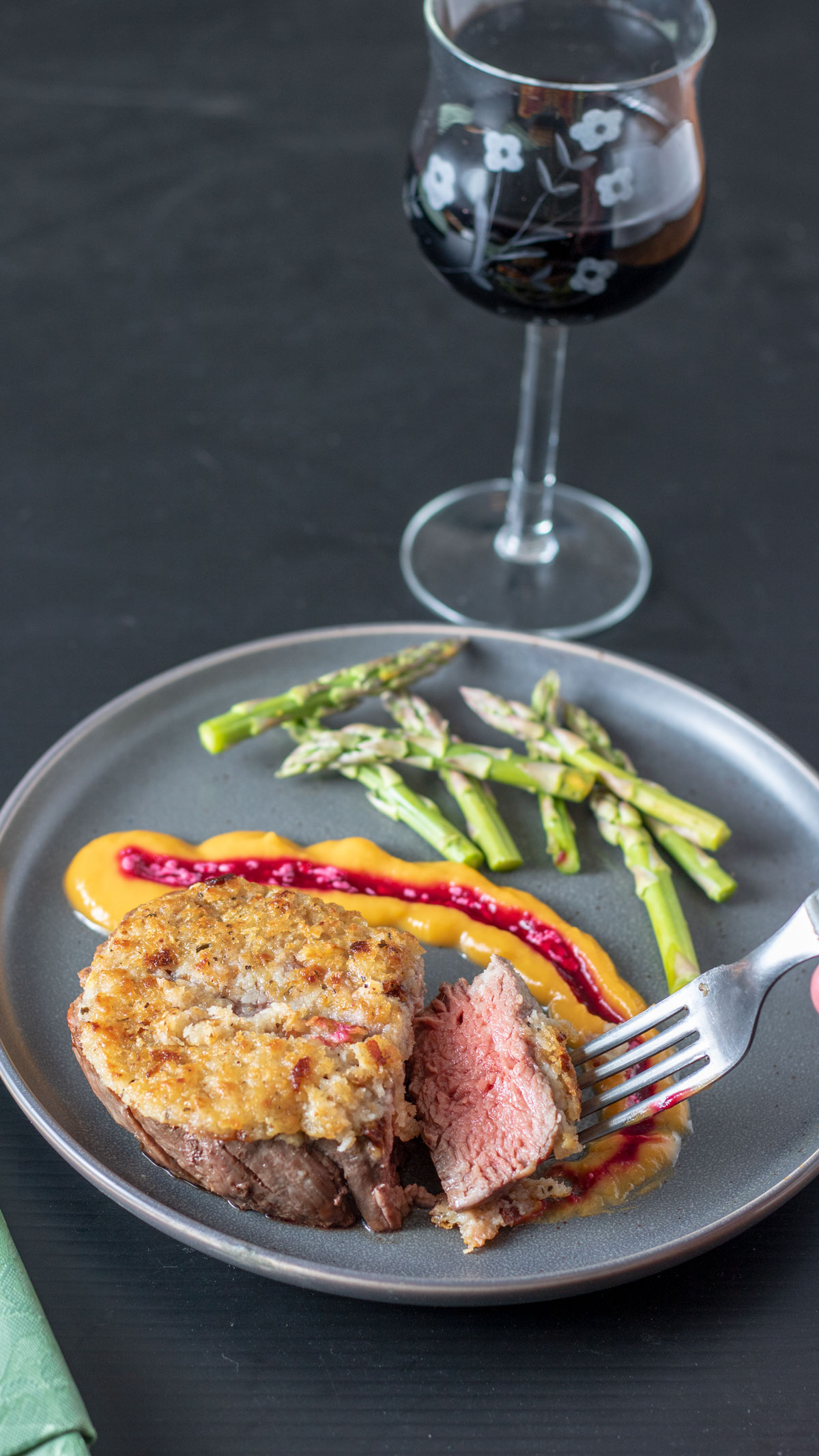 Beef filet on gray plate with sliced removed, showing pink interior.