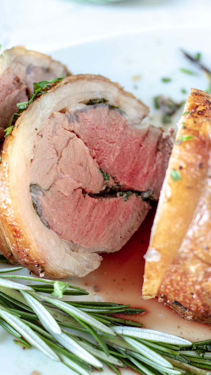 slices of lamb on white platter close up