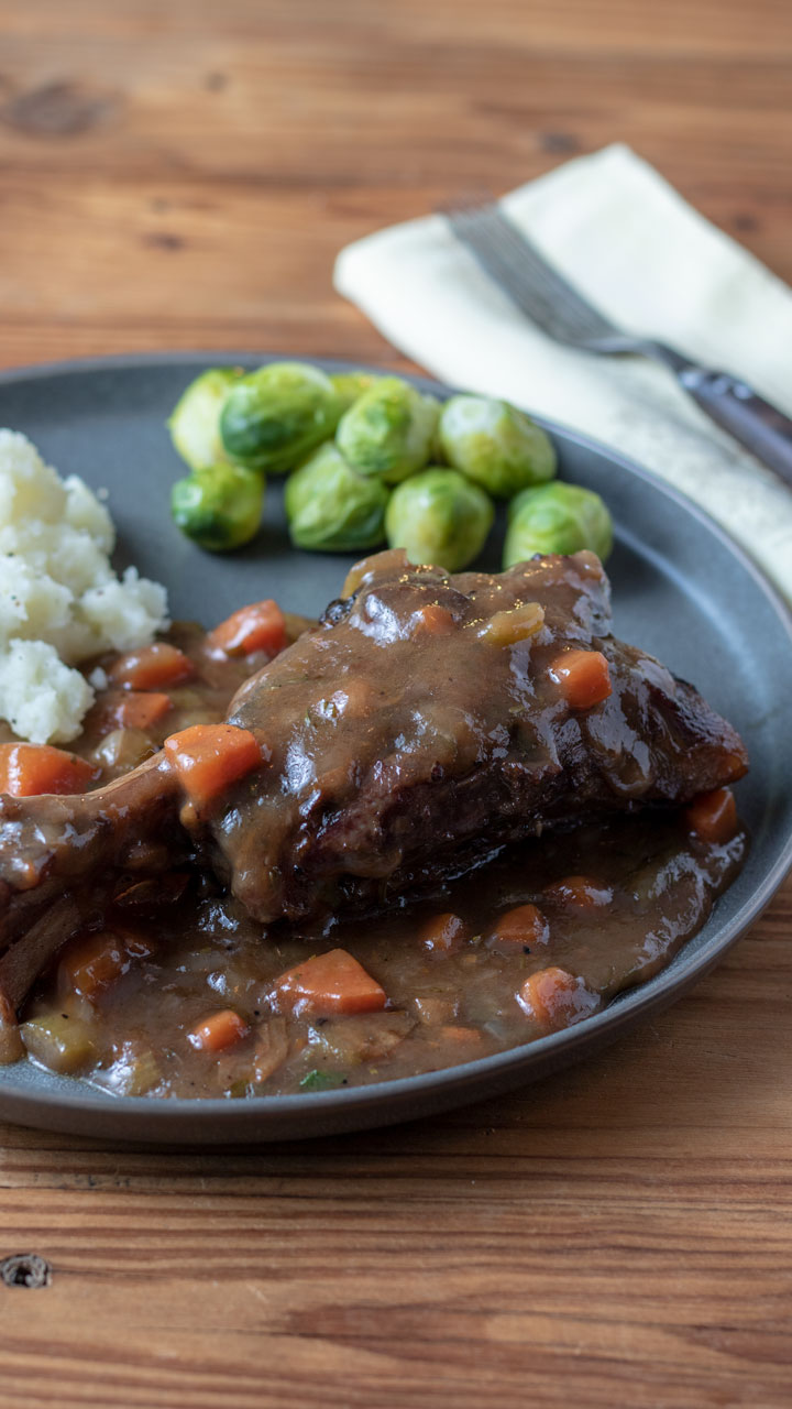 Gray plate with lamb dinner.