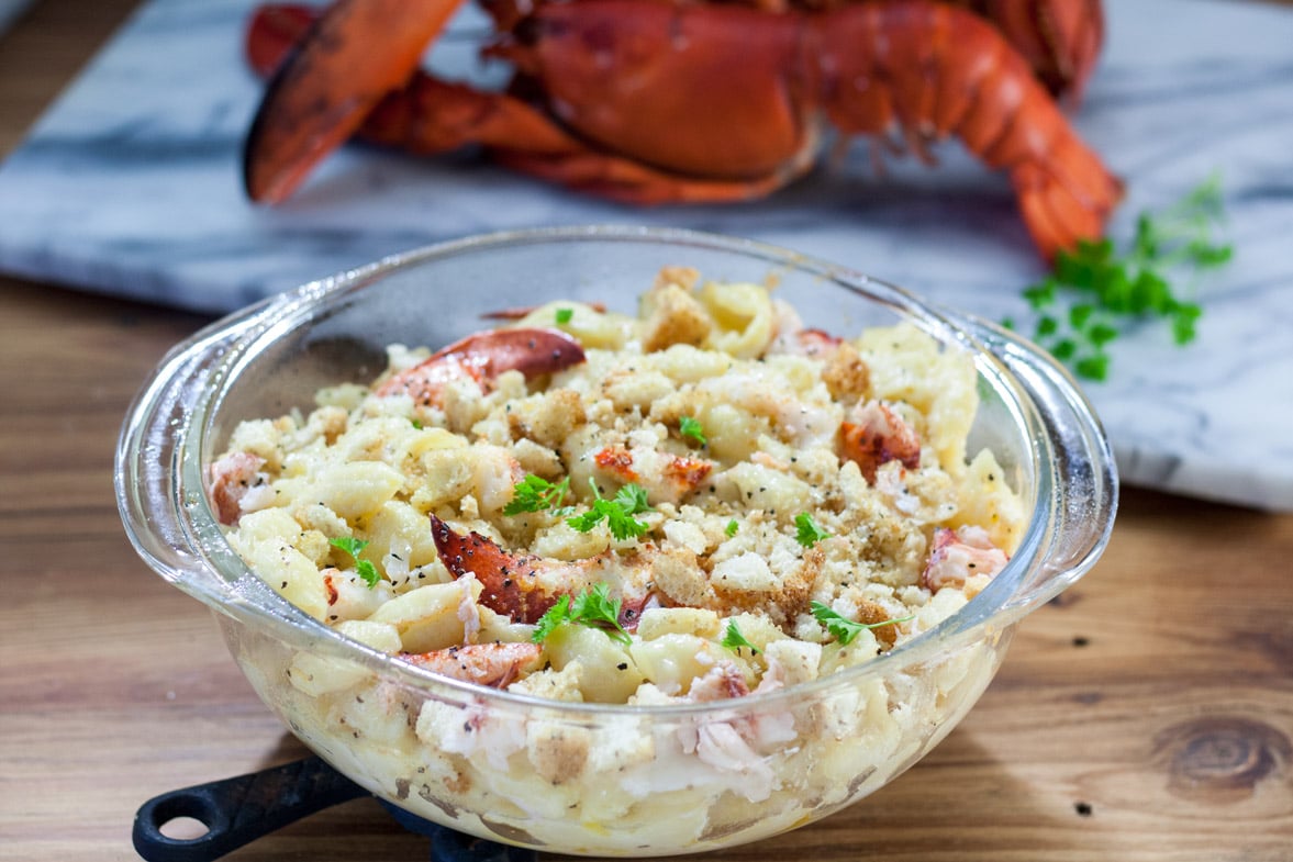 Lobster Mac and cheese recipe in clear casserole with large chunks of lobster