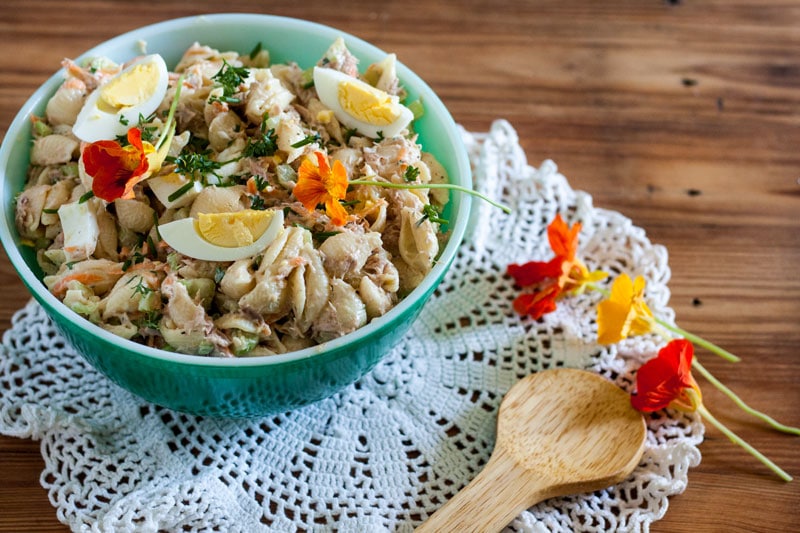 Macaroni salad with tuna in vintage green bowl.
