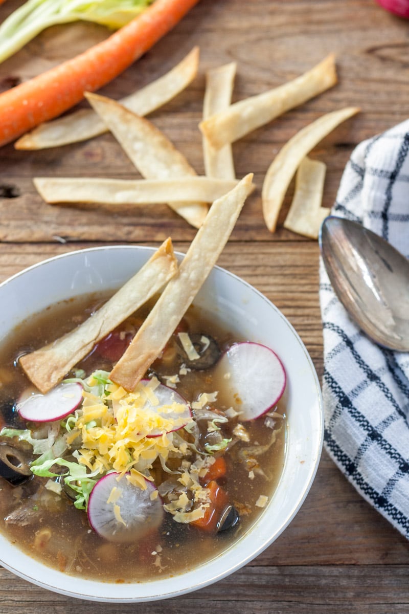 Mexican turkey soup with garnishes and home made tortilla chips