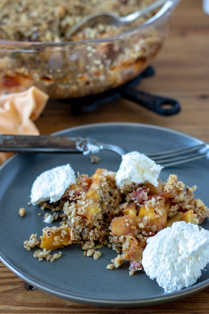Close up of crisp with oats and colorful peaches.