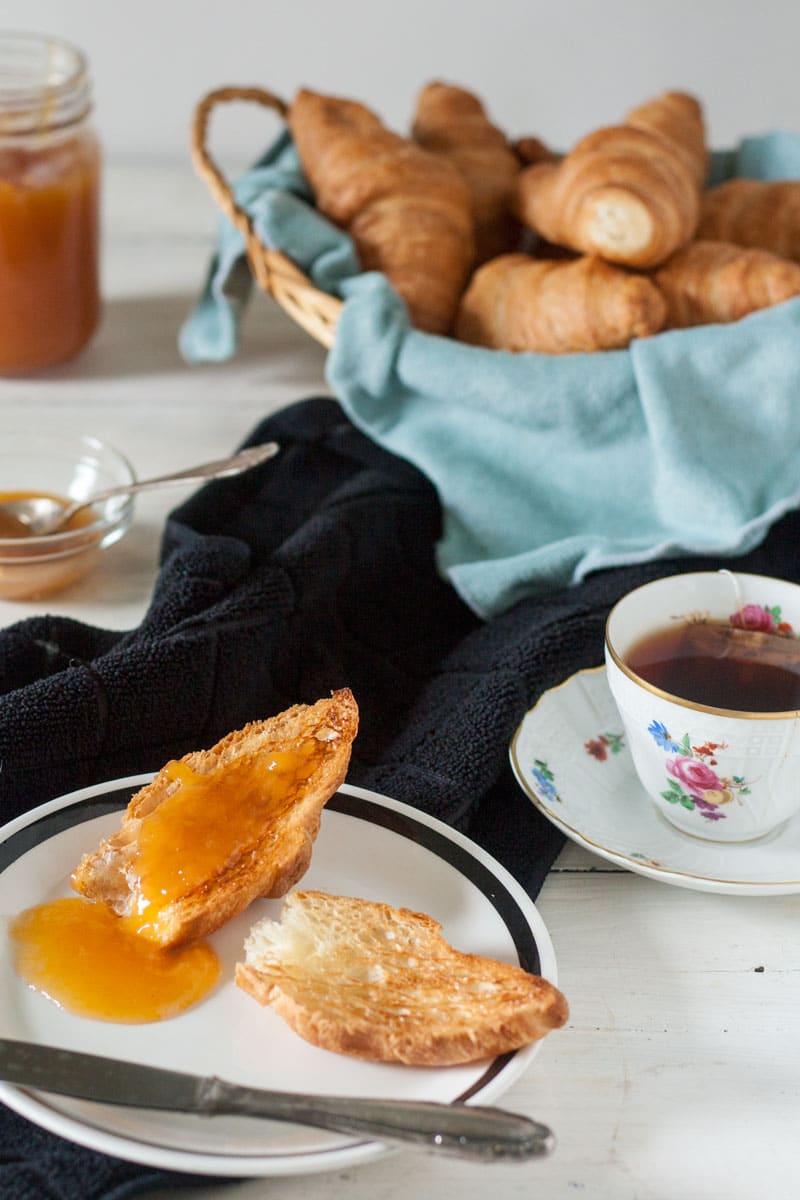 halved, toasted croisant with peach jam