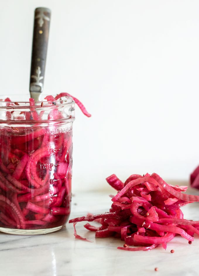 quick pickled onions on board and in jar