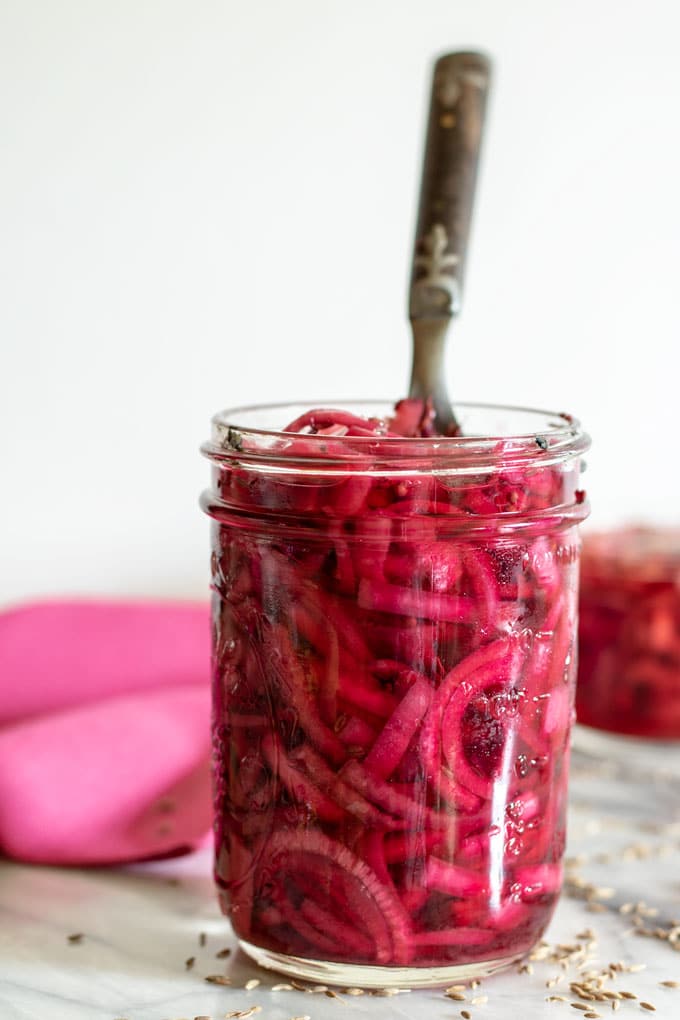 pickled onions in canning jar with fork